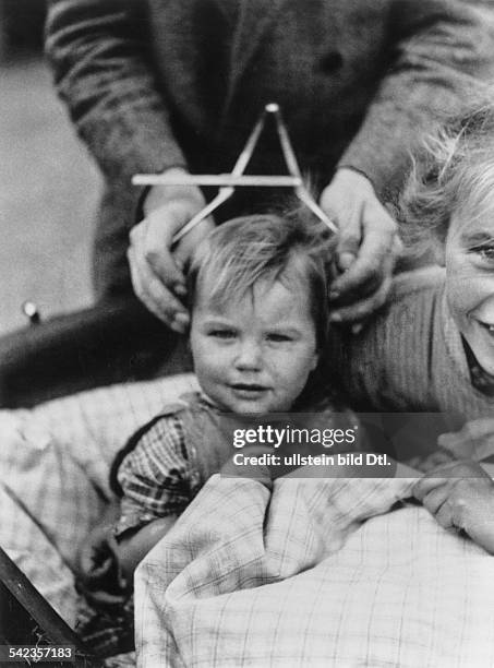 University professor at an anthropological institute in Schleswig-Holstein measures the cranium of a child, a practice widely encouraged by the...