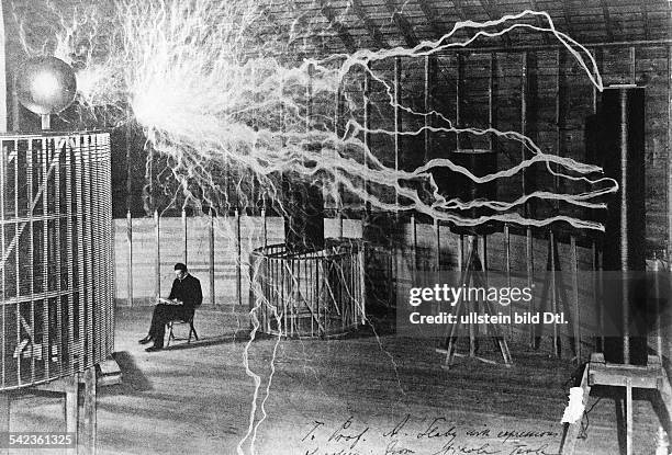 Serbian-American inventor, engineer and futurist Nikola Tesla studying electricity in the laboratory, circa 1899.