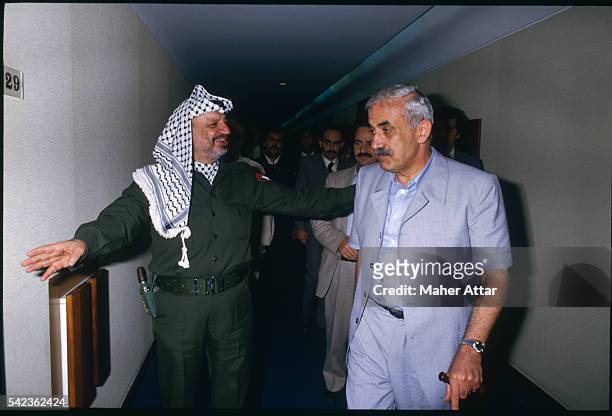 Yasser Arafat and P.F.L.P. Leader Georges Habache, meet again for the first time since 1982, during the National Palestine council in Algiers.