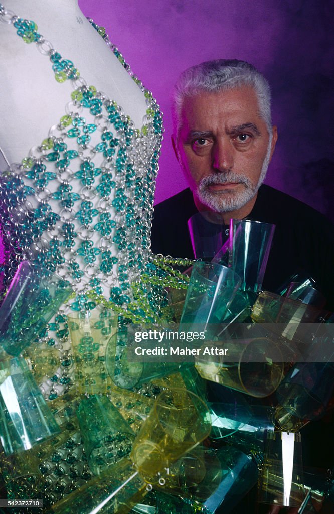 Portrait of fashion designer Paco Rabanne, next to a mannequin with a ...