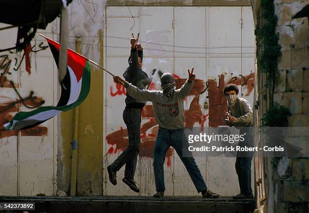 Demonstrators waving Palestinian Liberation Organization flags protest in the streets of Nablus after the Friday Prayer. Violence broke out after...