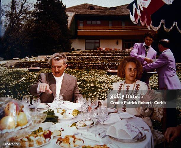 Romanian dictator Nicolae Ceausescu and his wife Elena eating a lavish dinner in an undated photograph from their family album. During his rule,...