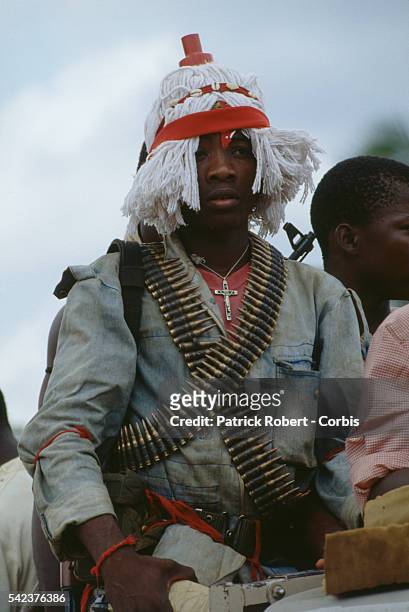Many members of the National Patriotic Front of Liberia don unusual outfits for spiritualistic reasons or scare tactics, like this young man who...