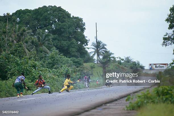 Guerilla forces from the National Patriotic Front of Liberia face fire from the Armed Forces of Liberia. Responding to years of government corruption...