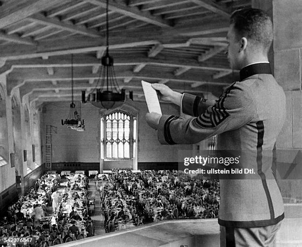 The United States Military Academy at West Point , officer training school :- a cadet reading the order of the day in the dining room - around 1936-...