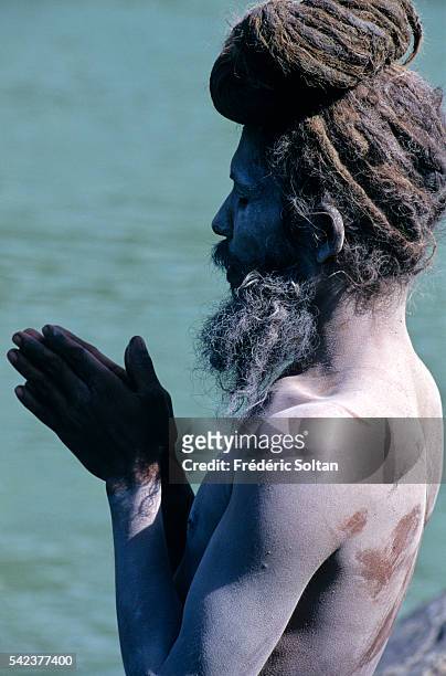 Rishikesh, located in the foothills of Himalaya, is an important center of pilgrimage for Hindus. Sadhu practicing yoga near the sacred river Ganges.