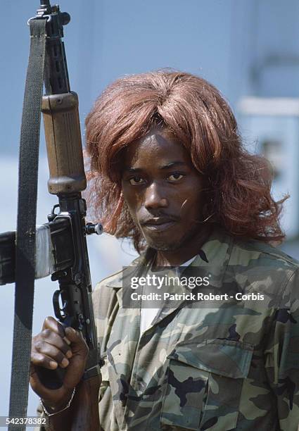 Member of the Independent National Patriotic Front of Liberia dresses himself in a wig, an act often done by rebel forces for spiritualistic reasons...