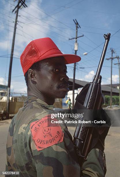 Member of the Independent National Patriotic Front of Liberia wears a patch reading, "Death before dishonor." Responding to years of government...