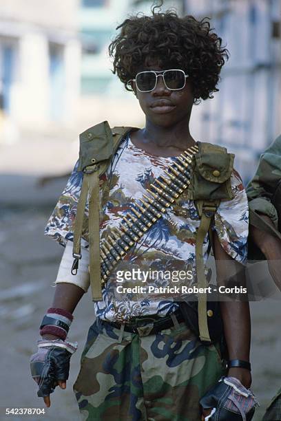 Member of the Independent National Patriotic Front of Liberia dresses himself in a wig, an act often done by rebel forces for spiritualistic reasons...