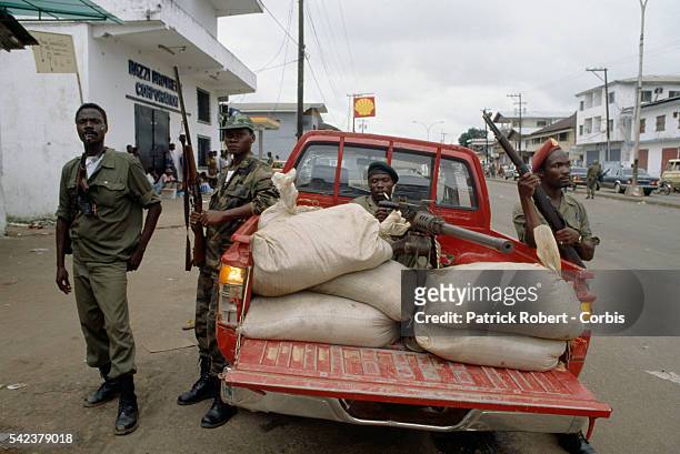 Members of the Independent National Patriotic Front of Liberia patrol the streets of Monrovia. Responding to years of government corruption and...