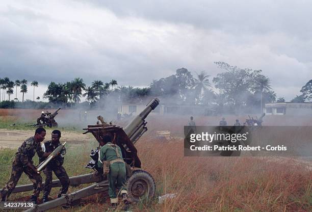 Soldiers from the multinational West African peacekeeping forces of ECOMOG engage in an artillery battle with the rebel troops of the National...