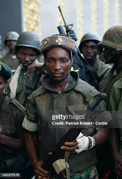 Colonel Michael Tilly, leader of the "Death Squad," a faction of President Samuel Doe's Armed Forces of Liberia , stands among his troops in...