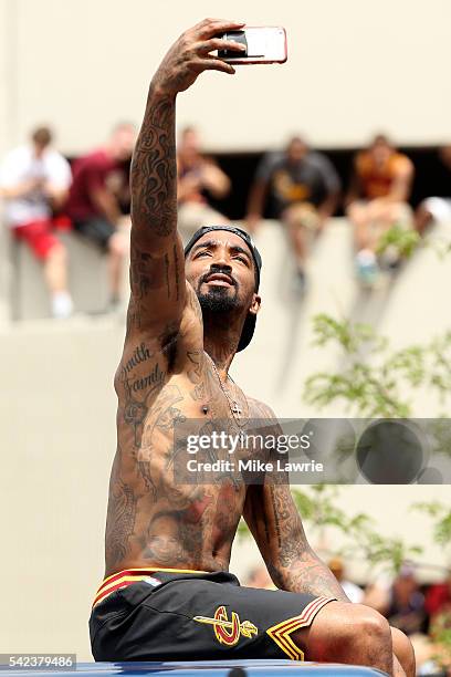 Smith of the Cleveland Cavaliers takes a photo as the crowd cheers during the Cleveland Cavaliers 2016 NBA Championship victory parade and rally on...