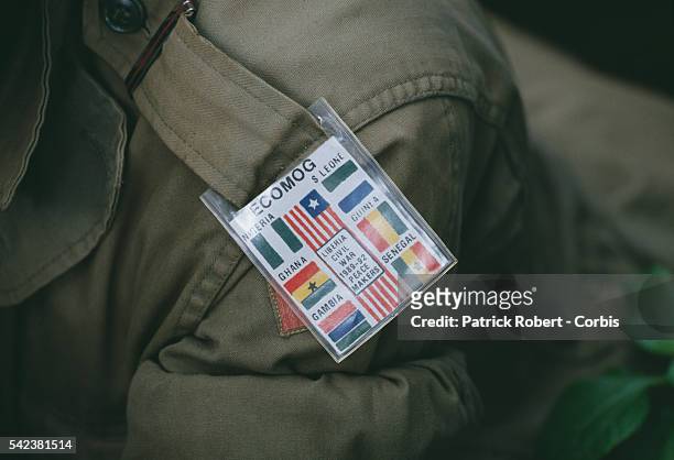 An ECOMOG soldier wears an arm band depicting other African conflicts with the mention "LIBERIA CIVIL WAR 1989-92 PEACE MAKERS." In 1989, Charles...