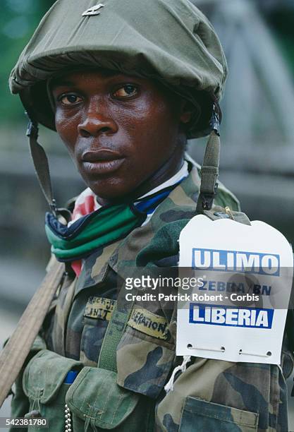 Soldier of the United Liberation Movement of Liberia for Democracy displays a tag with his fighting unit's name on his uniform during the Liberian...