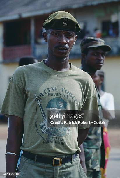Soldier of the United Liberation Movement of Liberia for Democracy wears a Special Forces t-shirt in Monrovia during the Liberian Civil War. In 1989,...