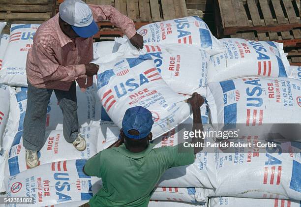 Men unload sacks of United Nations foodstuffs for people caught up in the communal conflict of the Liberian Civil War. In 1989, Charles Taylor,...