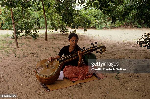 Musician of the school playing sitar. The Foundation was established in 1936 by Rukmini Devi to be a center of training and performance of the...