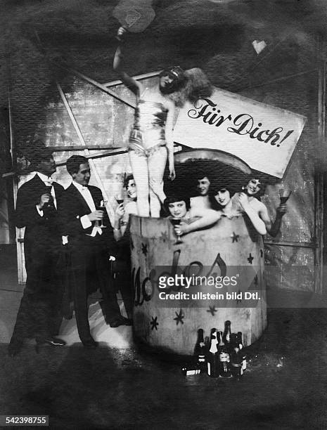 Germany Berlin: new year's eve - girls with champaigne glasses sitting in a wine barrel - from the Erik Charel revue 'For you'- 1926- Photographer:...