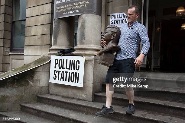 Workman removes the head of Joseph Stalin at the polling station at Shoreditch Town Hall during the UKs EU Referendum Polling Day on June 23rd 2016...