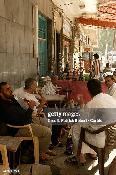 Everywhere in Iraq, television sets are tuned into the Arab-language station Al Jazeera or other Arabic channels, like in this traditional coffee...