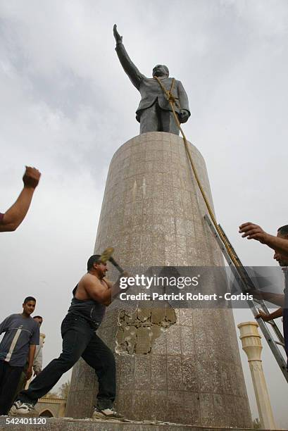 Saddam's Statue Taken Down By a U.S. Tank- A statue of Saddam Hussein is taken down as a symbolic gesture by an American tank, with the help of...