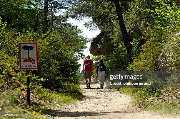 Ramblers walk in a national park in Chaos de Montpellier le Vieux in Aveyron.