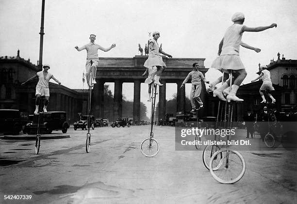 Germany Free State Prussia Berlin Berlin: Equilibrists Special performance of a unicycle troupe at Pariser Platz in front of Brandenburg Gate, Berlin...