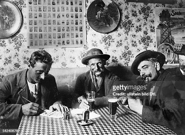 Men in a pub Three men in the Italian restaurant / pub Cocozza's in the Buchholzer Strasse in Prenzlauer Berg District, Berlin - 1901 - Vintage...