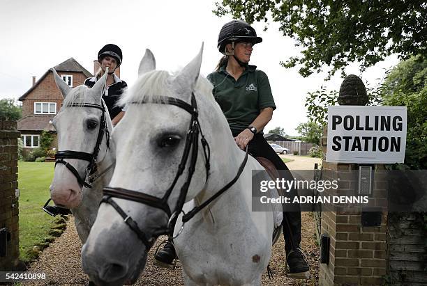 Jacqui Vaughan and Sophie Allison, riding horses Splash and Sharna, ride out of the driveway of a private residence, used as a polling station, near...