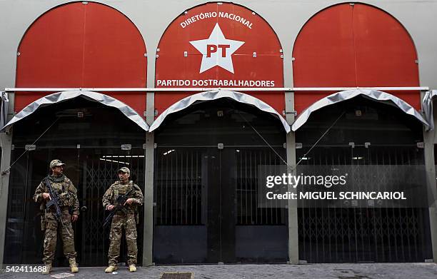 Brazilian Federal Police personnel keep watch in front of the national headquarters of the Worker's Party in Sao Paulo, Brazil on June 23, 2016. On...