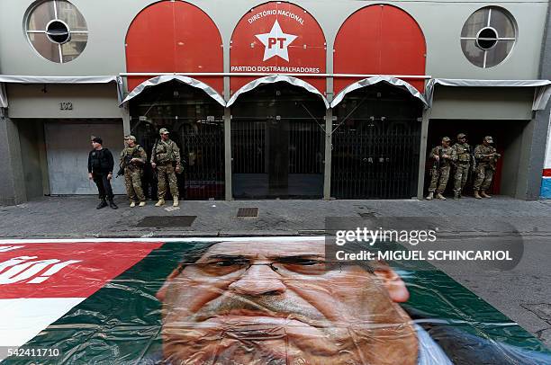 Brazilian Federal Police personnel keep watch in front of the national headquarters of the Worker's Party in Sao Paulo, Brazil on June 23, 2016. On...