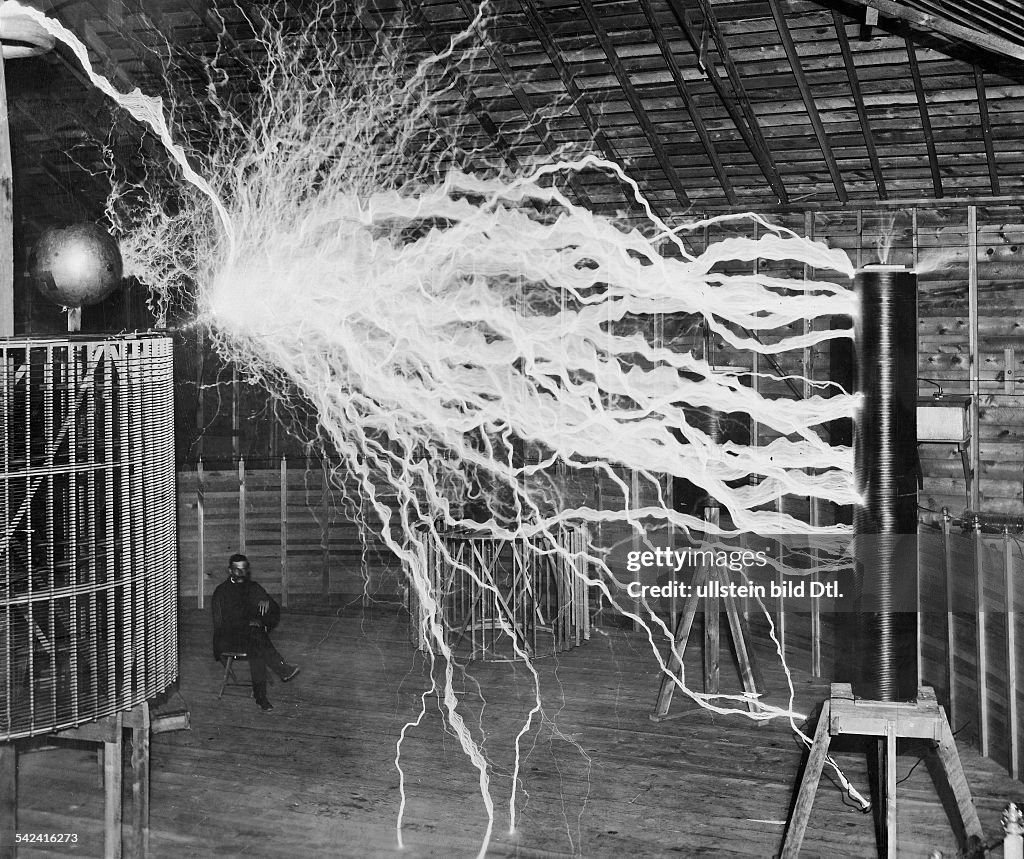Tesla studying electricity in the laboratory