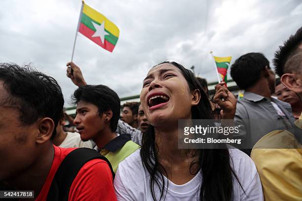 Burmese immigrant cries as she waits to see Myanmar Foreign Minister Aung San Suu Kyi at a wholesale fish market in Samut Sakhon, Thailand, on...