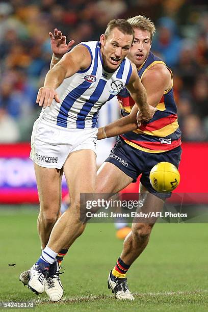 Drew Petrie of the Kangaroos is tackled by Daniel Talia of the Crows during the 2016 AFL Round 14 match between the Adelaide Crows and the North...