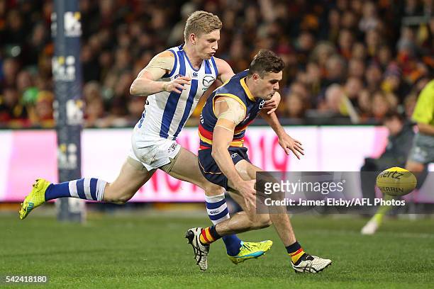 Jack Ziebell of the Kangaroos tackles Brad Crouch of the Crows during the 2016 AFL Round 14 match between the Adelaide Crows and the North Melbourne...