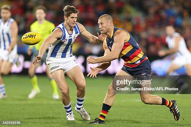 Trent Dumont of the Kangaroos competes with Scott Thompson of the Crows during the 2016 AFL Round 14 match between the Adelaide Crows and the North...