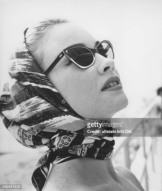 Young woman wearing horn-rimmed sunglasses with white dots - 1956