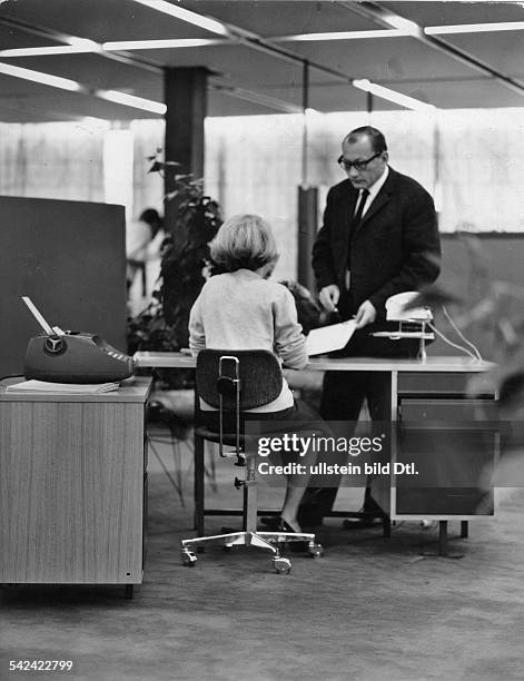 Sekretärin mit Chef am Schreibtisch ineinem Grossraumbüro- 1966
