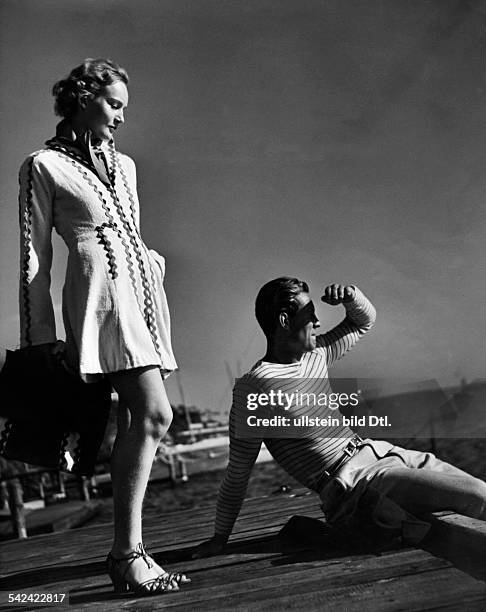 Fashion pictures Woman in a short white terry coat with green borders designed by the Berlin Textile and Fashion School, department Eva Lemke - 1937...