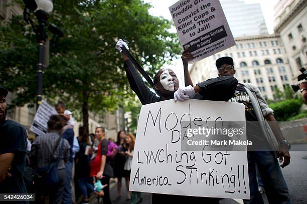 Angel Selah protests outside the Circuit Court before Baltimore police officer Caesar Goodson Jr. Was found not guilty on all charges on June 23,...