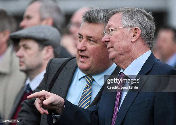 March 2015; Former Manchester United manager Sir Alex Ferguson, right, and trainer Paul Nicholls watch their horse Rainy City compete in The St...