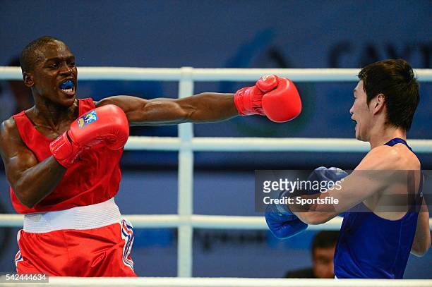 October 2013; Souleymane Cissokho, France, left, exchanges punches with Yasuhiro Suzuki, Japan, during their 69Kg preliminary bout. AIBA World Boxing...