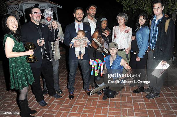 Writers Angela Kang, Matt Negrete and Carey Reed of 'The Walking Dead' pose with Reel Guise TWD cosplayers at the 42nd Annual Saturn Awards - After...