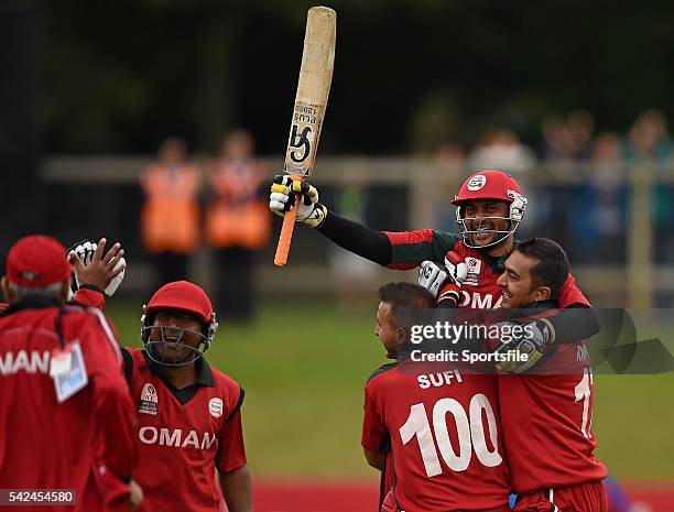 July 2015; Zeeshan Maqsood, Oman, is lifted by teammates Sufyan Mahmood and Rajeshkumar Ranpura after hitting the winning run to defeat Namibia. ICC...