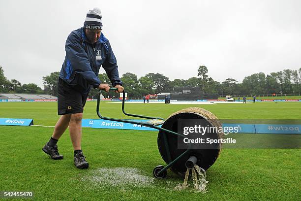 July 2015; Malahide Cricker Club Groundsman Howard Askew empties his blotter outside the boundary rope as him and his team look to dry the pitch...