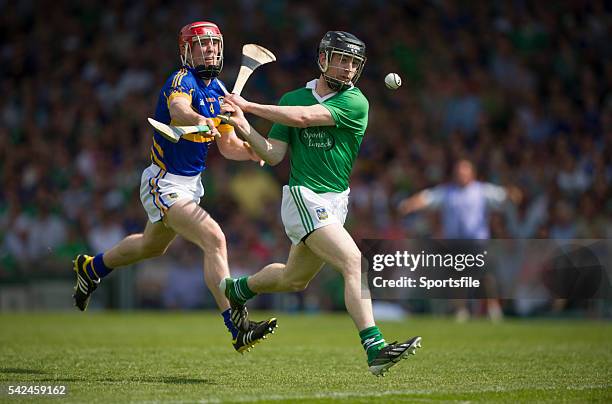 June 2013; Graeme Mulcahy, Limerick, attempts a shot on goal despite the best efforts of Michael Cahill, Tipperary. Munster GAA Hurling Senior...