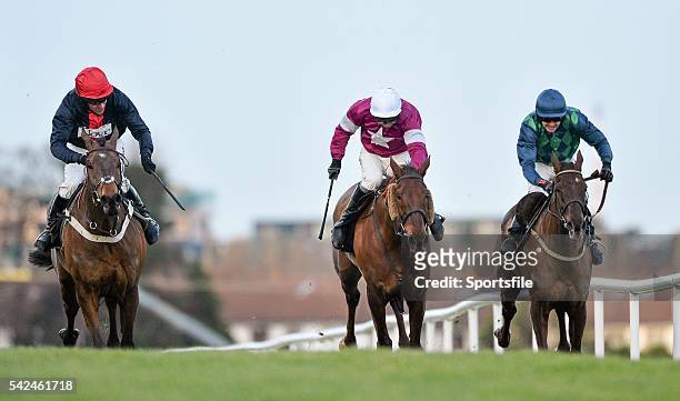 December 2013; Jockey Barry Geraghty, on board Bobs Worth, looks across as they race clear of First Lieutenant, centre, with David Casey up, and...