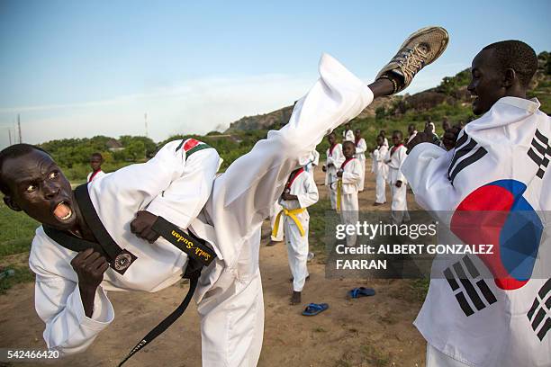 Taekwondo Masters Garang Garang and Emmanuel Malang demonstrate during their daily taekwondo training session at the Juba Jebel on June 23, 2016. The...