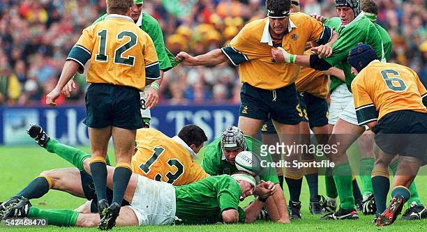 October 1999; Trevor Brennan and Andy Ward, Ireland, compete for the ball with Daniel Herbert, no.13 Australia. 1999 Rugby World Cup, Ireland v...